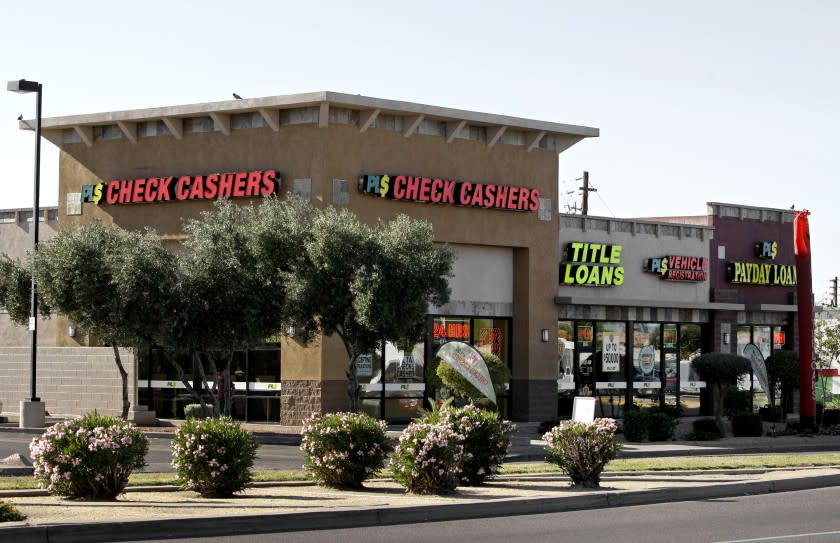 Signs adorn this payday loan business, one of 650 operating in the state and some open 24 a day in Phoenix in 2010.