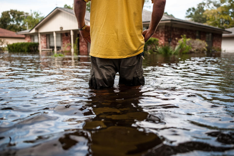 Oden &ldquo;Odie&rdquo; Walder walks up to his flooded home in Angleton, Texas, on Monday. (Photo: Joseph Rushmore for HuffPost)