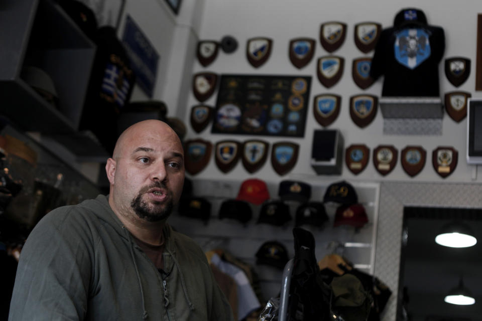 In this Oct. 26, 2012, photo, extreme far-right Golden Dawn party lawmaker Ilias Panagiotaros, speaks at his shop in central Athens, explaining his party's policies and rejects accusations that it has been involved in racist attacks in Greece. Human rights and immigrant groups say there has been an increase in racist attacks in Greece over the last year, as the country struggles through a protracted financial crisis. (AP Photo/Petros Giannakouris)