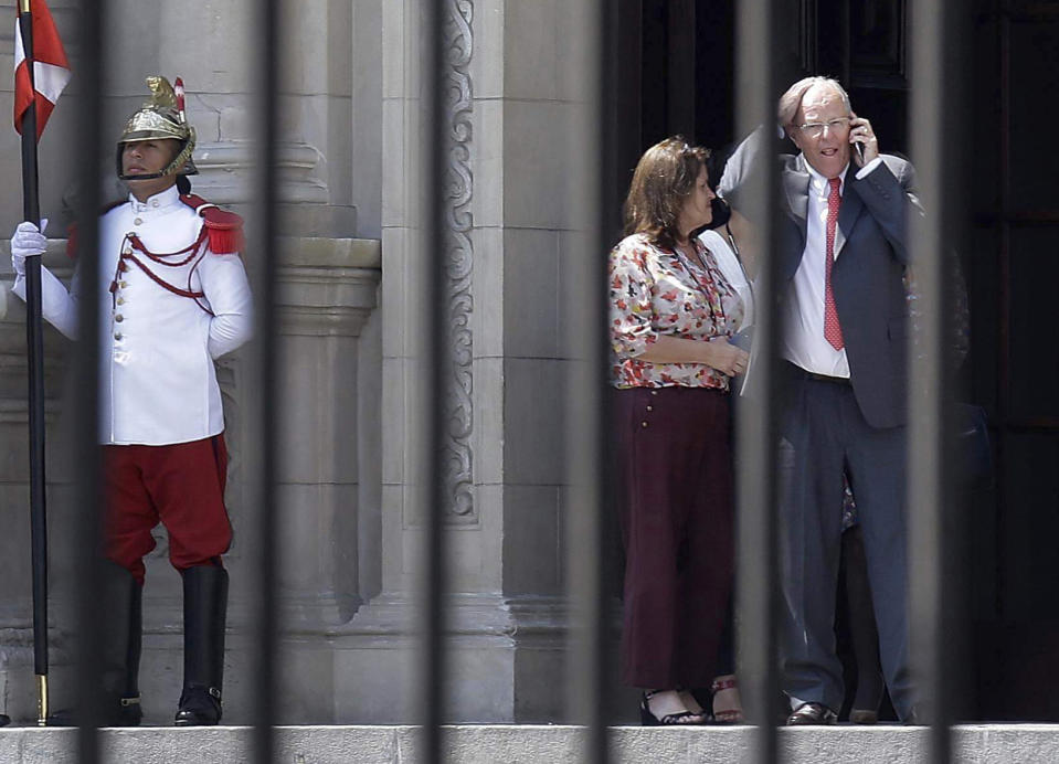 FILE - In this March 21, 2018 file photo, Peru's President Pedro Pablo Kuczynski talks on his cellphone as he vacates the House of Pizarro, the presidential residence and workplace, in Lima, Peru. The embattled Peruvian leader resigned ahead of a scheduled vote on whether to impeach the former Wall Street investor for his involvement in the Odebrecht scandal. (AP Photo/Martin Mejia)