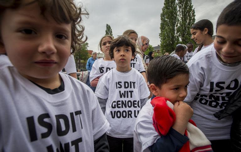 Pupils from a primary school in Amsterdam wear T-shirts that read 'Is this white enough for you?'