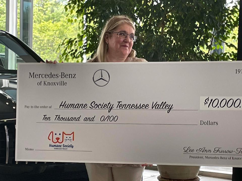 Constance Paras, executive director of the Humane Society of Tennessee Valley, receives $10,000 from the Furrow Automotive Group’s Mercedes-Benz of Knoxville at a presentation held at the dealership Thursday, July 21, 2022.