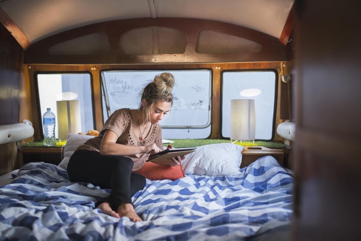 woman using digital tablet in campervan