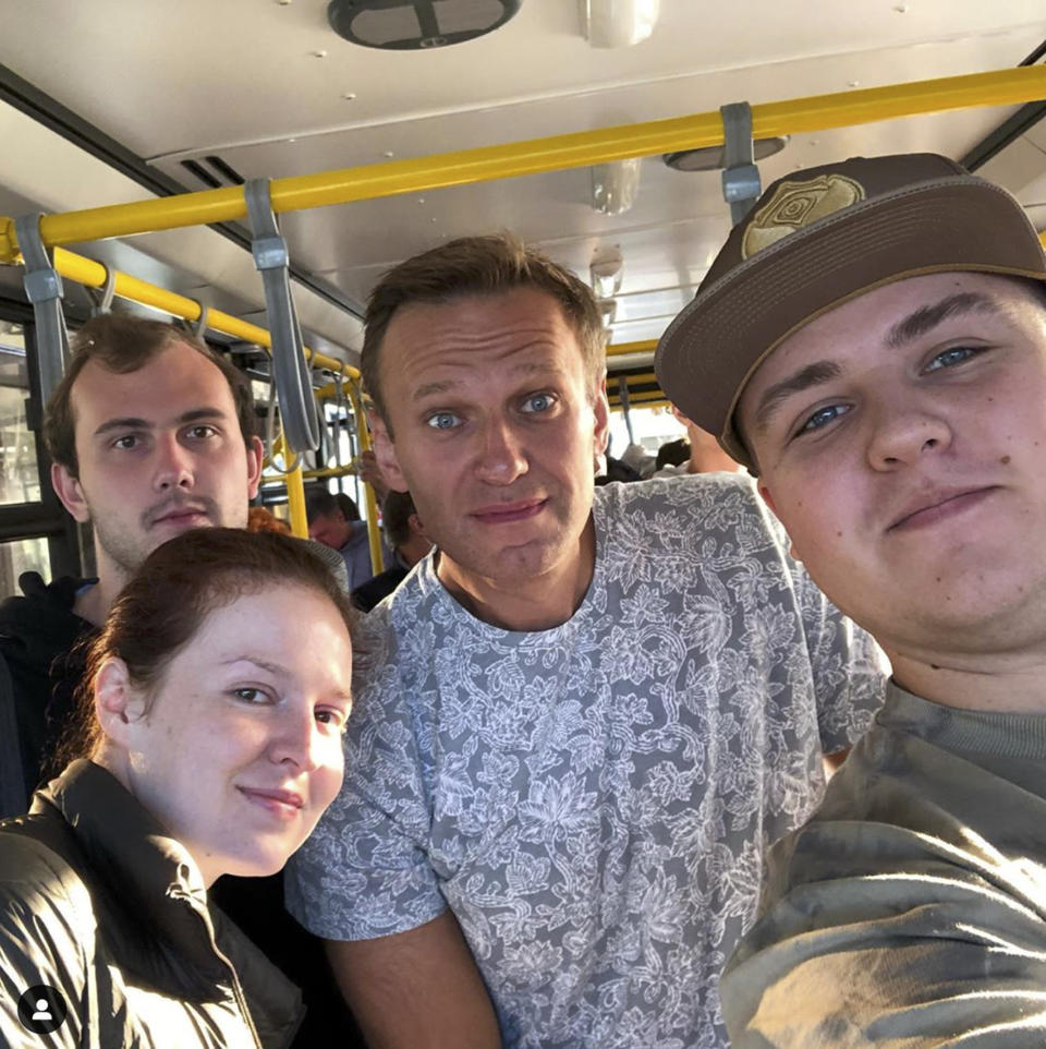 FILE - In this file photo taken provided gluchinskiy, Russian opposition leader Alexei Navalny, center, and Kira Yarmysh, foreground left, pose for a selfie inside a bus on their way to an aircraft at an airport outside Tomsk, a city in Siberia, Russia Thursday, Aug. 20, 2020. German Chancellor Angela Merkel says Russian opposition leader Alexei Navalny was the victim of an "attempted murder by poisoning" and the aim was to silence him. Navalny was poisoned with the same type of Soviet-era nerve agent that British authorities identified in a 2018 attack on a former Russian spy, the German government said Wednesday, Sept. 2, 2020 citing new test results. (gluchinskiy via AP, File)