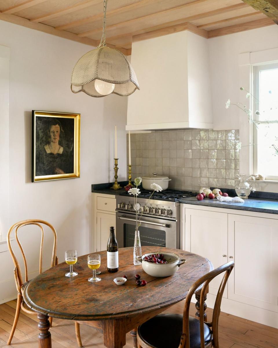 creamy white kitchen with rustic table