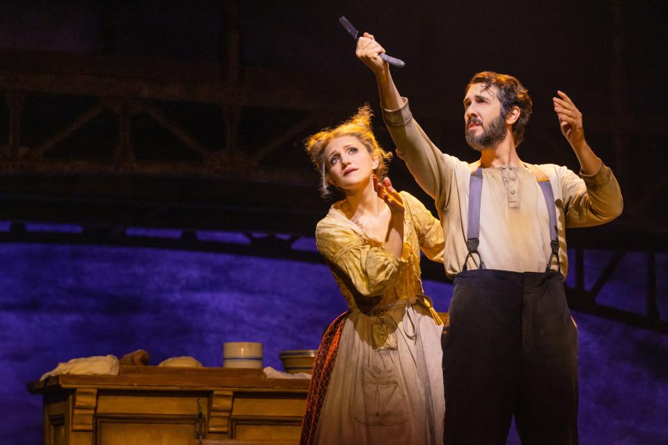 Sweeney Todd (Josh Groban, right) gazes fondly at his razor as Mrs. Lovett (Annaleigh Ashford) looks on.