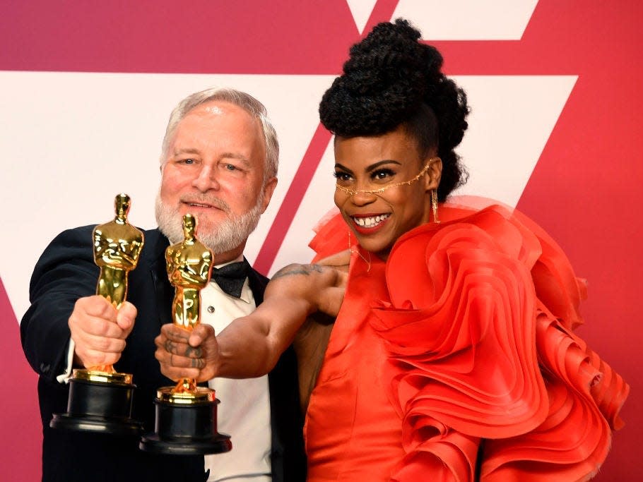 Jay Hart and Hannah Beachler hold their Oscars for best production design for "Black Panther"