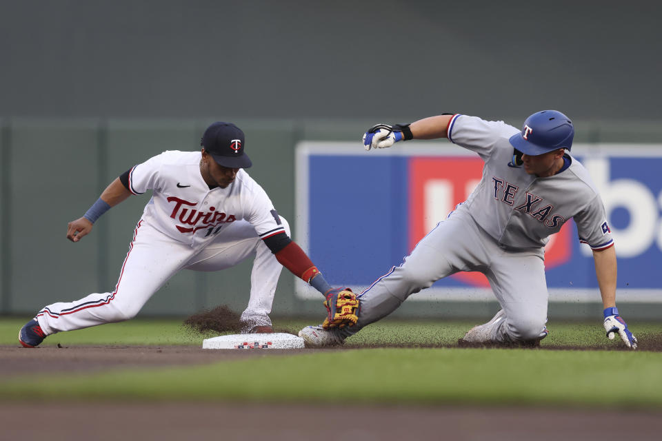 Texas Rangers' Corey Seager arrives at second with a double next to Minnesota Twins second baseman Jorge Polanco during the first inning of a baseball game Friday, Aug. 25, 2023, in Minneapolis. (AP Photo/Stacy Bengs)