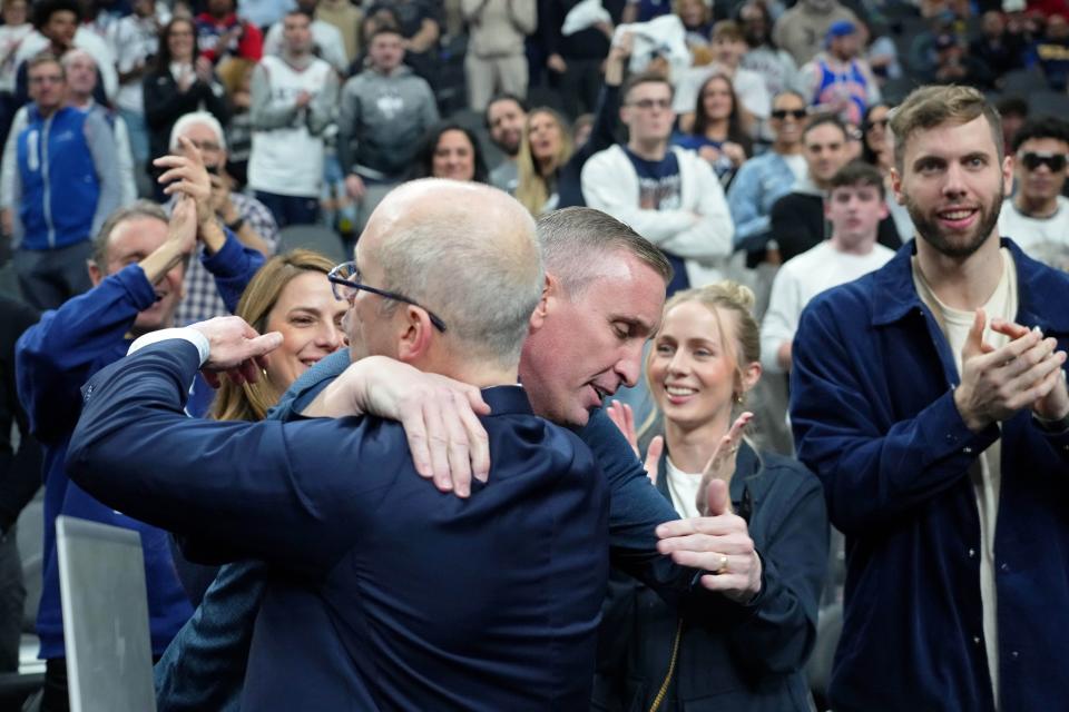 UConn Huskies head coach Dan Hurley (left) hugs his brother Bobby Hurley (right) after their win against the Arkansas Razorbacks at T-Mobile Arena in Las Vegas on March 23, 2023.