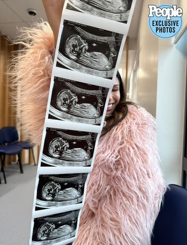 <p>emily-miller-123123</p> Emily Miller holding a sonogram.