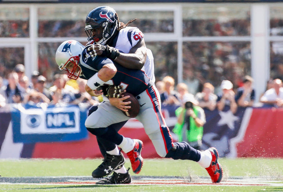 <p>Tom Brady #12 of the New England Patriots is sacked by Jadeveon Clowney #90 of the Houston Texans during the second quarter of a game at Gillette Stadium on September 24, 2017 in Foxboro, Massachusetts. (Photo by Jim Rogash/Getty Images) </p>