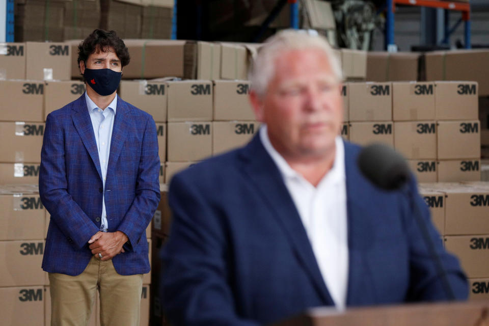 Canada's Prime Minister Justin Trudeau listens to Ontario Premier Doug Ford during a visit at 3M's plant in Brockville, Ontario, Canada August 21, 2020. REUTERS/Lars Hagberg