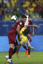 Brazil's Dani Alves, right, fights for the ball with Venezuela's Junior Moreno during a Copa America Group A soccer match at the Arena Fonte Nova in Salvador, Brazil, Tuesday, June 18, 2019. (AP Photo/Ricardo Mazalan)