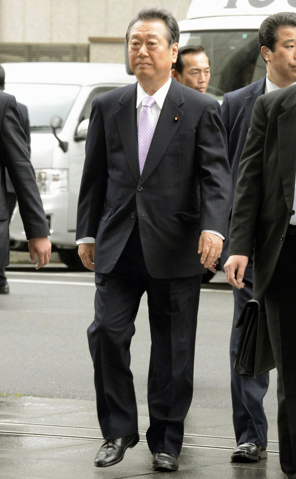 Ichiro Ozawa, a powerbroker of the ruling Democratic Party of Japan, arrives at the Tokyo District Court in Tokyo Thursday, April 26, 2012. The court acquitted the veteran lawmaker Thursday in a political funding scandal. Ozawa was charged last year with overseeing false accounting by his former aides in a murky 2004 land deal. (AP Photo/Kyodo News) JAPAN OUT, MANDATORY CREDIT, NO LICENSING IN CHINA, HONG KONG, JAPAN, SOUTH KOREA AND FRANCE