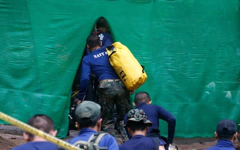 Rescuers arrive nearthe cave where 12 boys and their football coach have been trapped since June 23 - Credit: AP