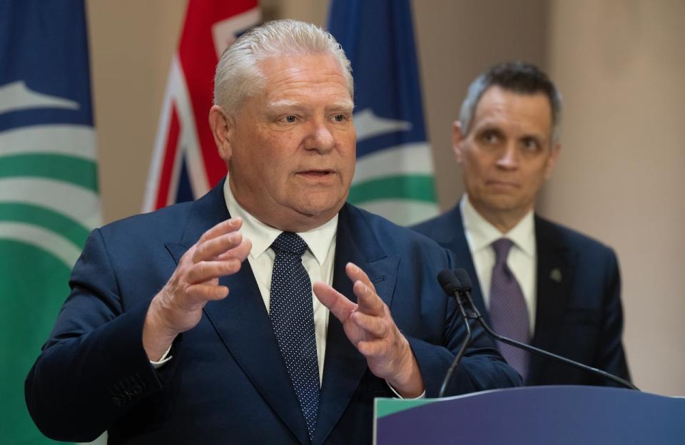 Ottawa Mayor Mark Sutcliffe looks on as Ontario Premier Doug Ford speaks during an announcement on Friday, April 5, 2024 in Ottawa.