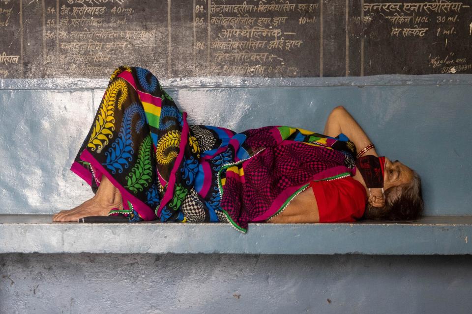 A woman with breathing problems waits for treatment at a health centre, amidst the coronavirus disease (COVID-19) pandemic, in Muzaffarnagar, Uttar Pradesh, India, May 11, 2021