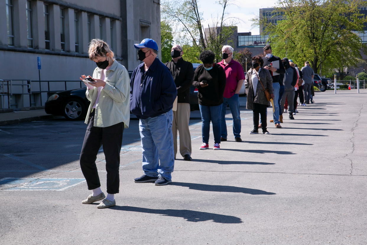 People line up outside a newly reopened career center