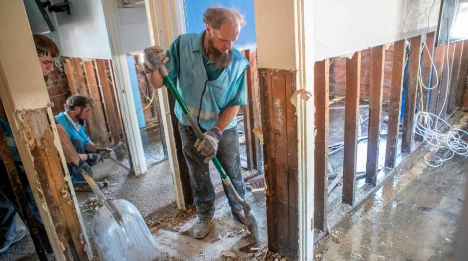 Volunteers with Christian Aid Ministries rapid response team remove damaged drywall, carpet, flooring and other items from flooded homes in the Terrace Dr. and Mary Ave. neighborhood in East St. Louis. The organization had about 20 volunteers from Ava and Arthur, Illinois regions.