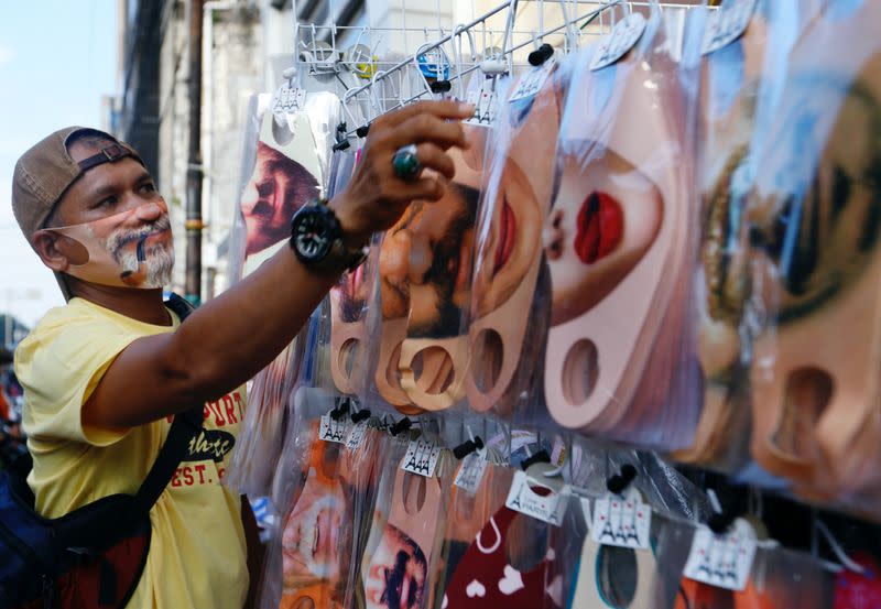 A vendor sells face design masks at a traditional market to prevent the spread of the coronavirus disease (COVID-19) outbreak, in Jakarta