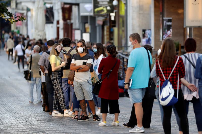People wait in a line to get tested for the coronavirus disease in Prague