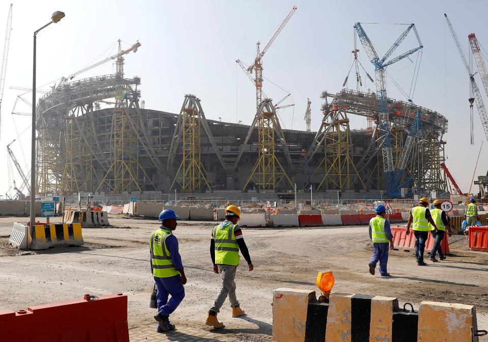 Workers walk towards the construction site of the Lusail Stadium, which will host the World Cup final in 2022 (REUTERS)