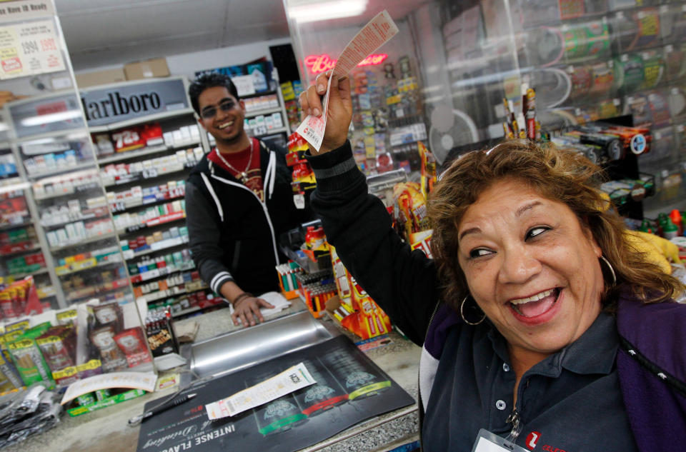 Raising her Power Ball ticket in the air Hortcina Martinez, who plays power ball weekly, shouts in excitement in hopes of winning jackpot from a ticket purchased at Oscar's Food Mart #1 on Tuesday, Nov. 27, 2012, in Houston. Wednesday's Powerball jackpot was raised to $500 million from $425 million. (AP Photo/Houston Chronicle, Mayra Beltran)