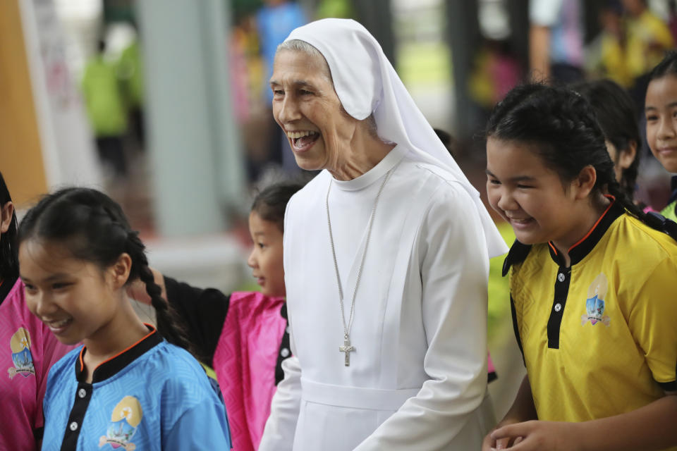 In this Aug. 27, 2019, photo, ST. Mary's School Vice Principal Sister Ana Rosa Sivori, center, talks to students during a lunch break at the girls' school in Udon Thani, about 570 kilometers (355 miles) northeast of Bangkok, Thailand. Sister Ana Rosa Sivori, originally from Buenos Aires in Argentina, shares a great-grandfather with Jorge Mario Bergoglio, who, six years ago, became Pope Francis. So, she and the pontiff are second cousins. (AP Photo/Sakchai Lalit)