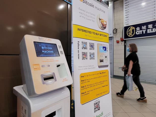 A shopper walks past a  Bitcoin Machine offering the sale and purchase of bitcoin in a Shopping mall in Singapore, 20 May 2021. (Photo by Joseph Nair/NurPhoto via Getty Images) (Photo: NurPhoto via Getty Images)