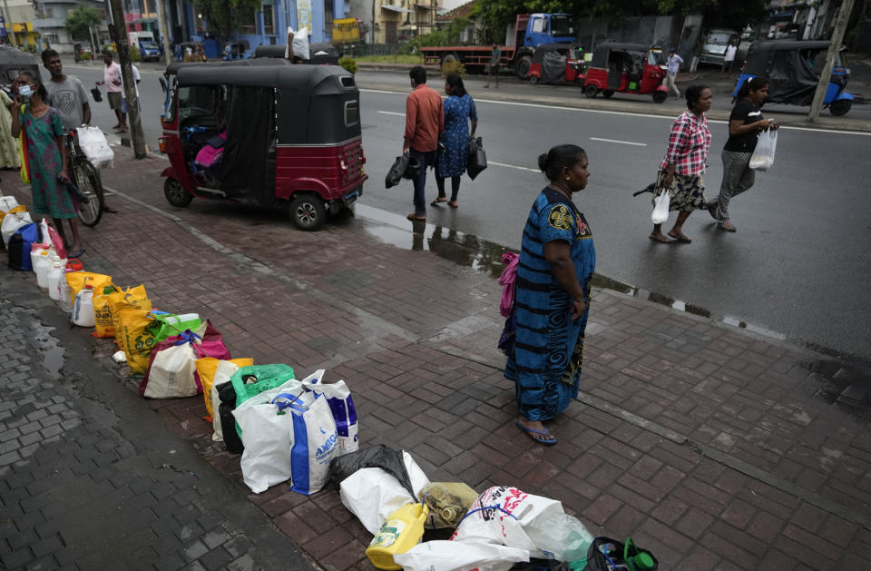 People place their canisters in line as they wait to buy kerosene oil outside a fuel station in Colombo, Sri Lanka, Saturday, June 11, 2022. Sri Lanka's prime minister says he may be compelled to buy more oil from Russia as he hunts desperately for more fuel to keep the country running. In an interview with The Associated Press on Saturday, Prime Minister Ranil Wickremesinghe said if the island nation can get the oil from other sources, it will. (AP Photo/Eranga Jayawardena)
