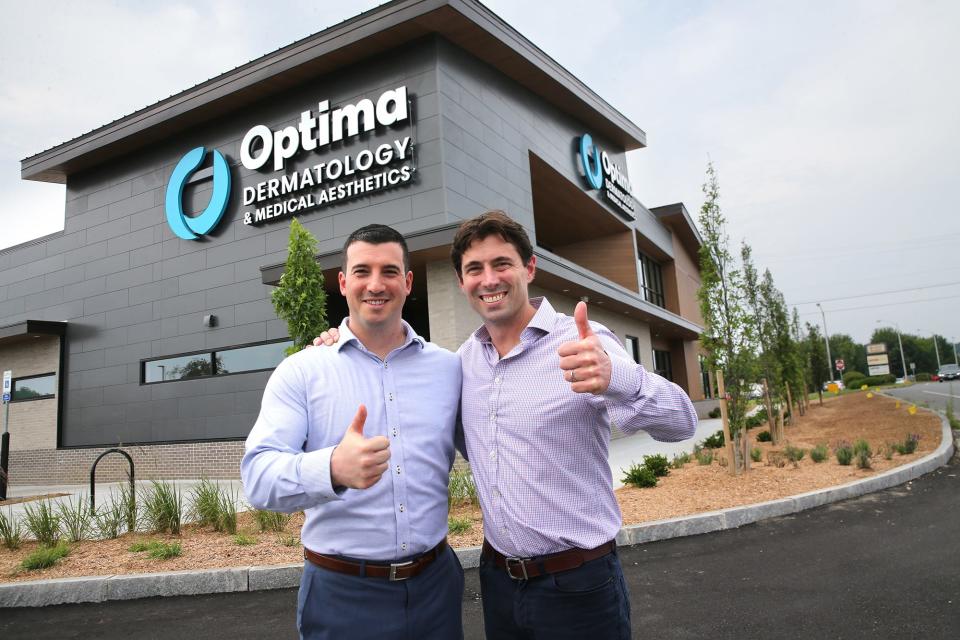 Ben Collins, chief growth officer at Optima Dermatology, left, and CEO Max Puyanic give a thumbs up during the grand opening of the Stratham facility July 13, 2023.