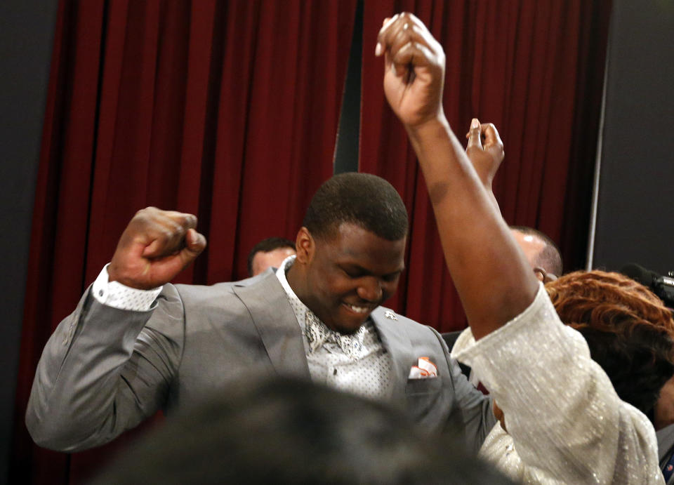 Greg Robinson, from Auburn, celebrates after being selected second overall in the first round of the NFL football draft by the St. Louis Rams, Thursday, May 8, 2014, at Radio City Music Hall in New York. (AP Photo/Jason DeCrow)