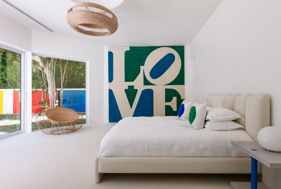 5) Another bedroom showcases the fashion designer's passion for colorful art.