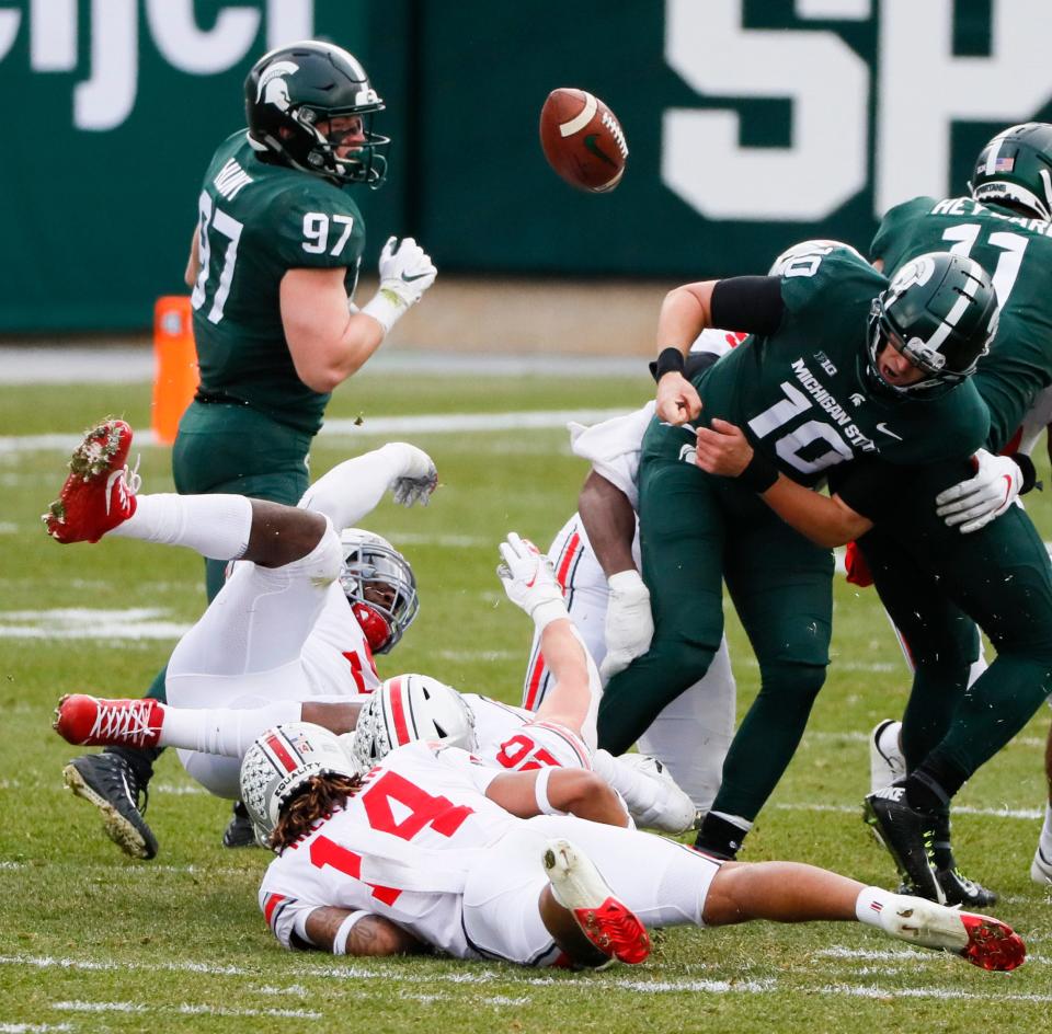 Michigan State Spartans quarterback Payton Thorne (10) fumbles the ball during the second quarter vs. the Ohio State Buckeyes on Saturday, Dec. 5, 2020 at Spartan Stadium in East Lansing, Michigan.