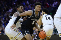 Providence's Ed Croswell (5) dribbles past Villanova's Eric Dixon during the second half of an NCAA college basketball game, Sunday, Jan. 29, 2023, in Philadelphia. (AP Photo/Derik Hamilton)