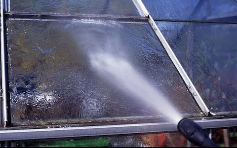 Clean glass with a pressure washer - Credit: Alec Scaresbrook / Alamy