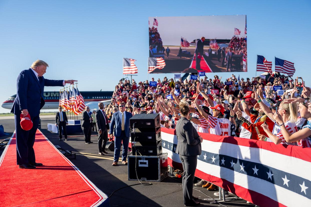 Former US President Donald Trump points to crowd members before taking the stage at a 2024 campaign rally at the Waco Regional Airport on March 25, 2023 in Waco, Texas.