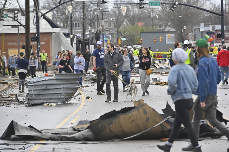 People view damage along Woodland Street after a tornado touched down in Nashville