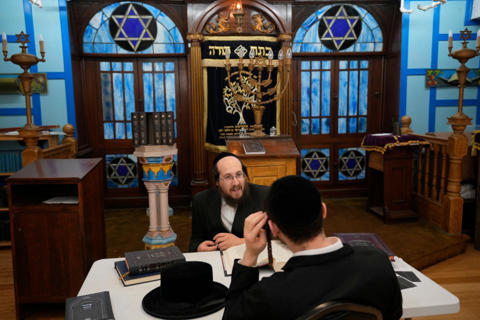 Mr. Konig speaks to a student at Yeshiva Ohel Shlome Sanz Zvill.  The school, which is based in Union City, also holds classes here, at Congregation Mt. Sinai, in Jersey City.  The students were unaware of the threat announcement released by the FBI when they came to class Thursday evening. Thursday, November 3, 2022