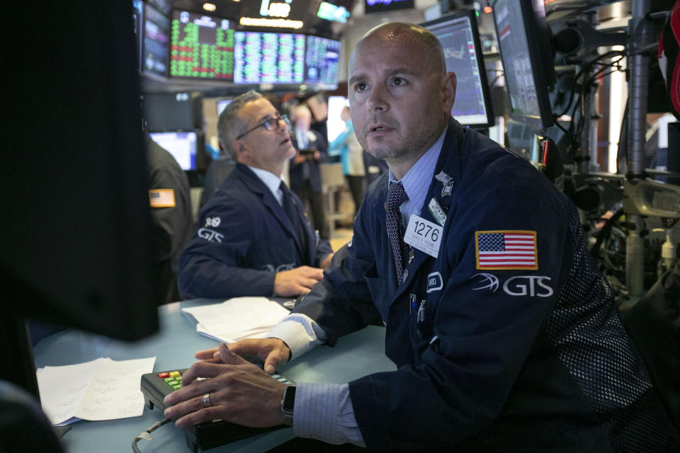 Specialist Mario Picone, right, works at his post on the floor of the New York Stock Exchange, Tuesday, June 11, 2019. Stocks are rising early Tuesday as Wall Street continues to thrive in June. (AP Photo/Richard Drew)