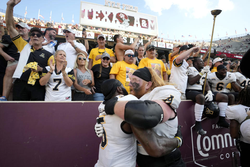 Appalachian State offensive lineman Bucky Williams, right, celebrates with Nate Noel, left, after the team's 17-14 win over No. 6 Texas A&M in an NCAA college football game Saturday, Sept. 10, 2022, in College Station, Texas. (AP Photo/Sam Craft)