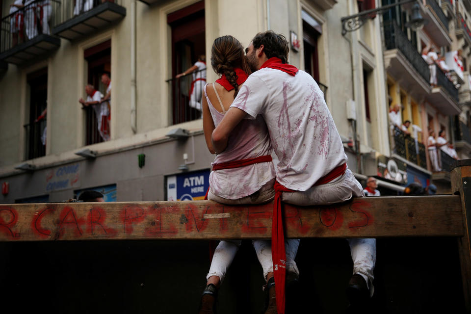 <p>Revellers sit on the bull run barrier before the first running of the bulls at the San Fermin festival in Pamplona, northern Spain, July 7, 2017. (Susana Vera/Reuters) </p>