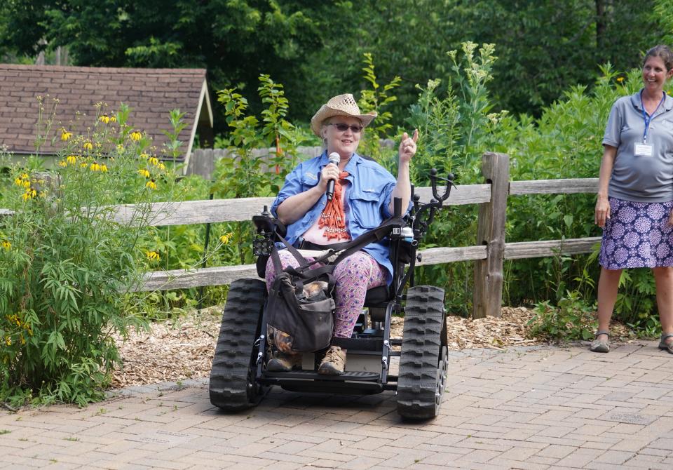 Monica Spaeni, president of Access Ability Wisconsin, speaks July 13 at a dedication of an outdoor wheelchair for public use at Wehr Nature Center. Carly Hintz, director of Wehr, is at right.