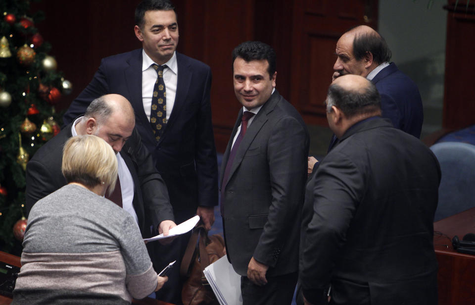 Macedonian Prime Minister Zoran Zaev, center, looks on following his speech on a session of the Macedonian Parliament in the capital Skopje, Wednesday, Jan. 9, 2019. Macedonian lawmakers were in the final stretch Wednesday of renaming their country North Macedonia as part of a deal with neighboring Greece in return for membership of NATO and potentially the European Union. (AP Photo/Boris Grdanoski)