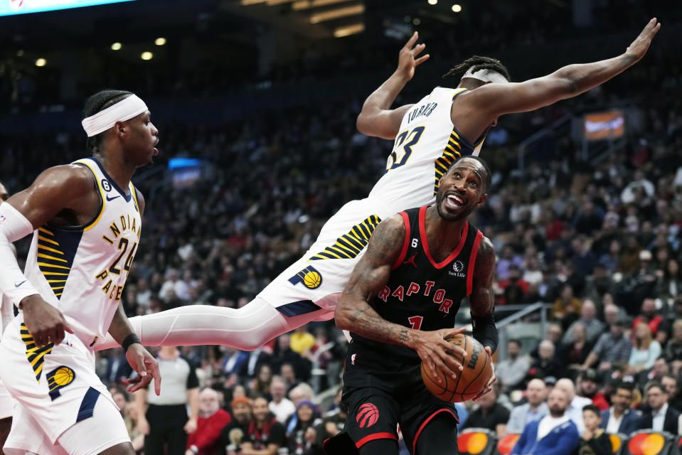 Toronto Raptors guard Will Barton (1) looks to shoot as Indiana Pacers centre Myles Turner (33) jumps past him and Indiana Pacers guard Buddy Hield (24) defends during the first half of an NBA basketball game in Toronto, Wednesday, March 22, 2023. (Frank Gunn/The Canadian Press via AP)