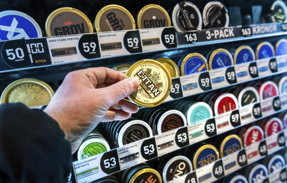 FILE - A man holds a box of snus (snuff), at a store in Stockholm, on Jan. 23, 2023. Sweden, which has the lowest rate of smoking in Europe is now close to declaring itself “smoke free,” defined as having less than 5% daily smokers in the population. Some experts give credit to decades of anti-smoking campaigns and legislation, while others point to the prevalence of “snus,” a smokeless tobacco product that’s illegal elsewhere in the European Union but is marketed in Sweden as an alternative to cigarettes. (Claudio Bresciani /TT News Agency via AP, File)