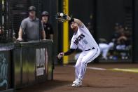 Arizona Diamondbacks left fielder Jordan Luplow makes a catch on a foul ball hit by San Diego Padres' Jurickson Profar during the fourth inning of a baseball game Tuesday, June 28, 2022, in Phoenix. (AP Photo/Ross D. Franklin)