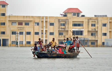 People are rescued from a flooded village in Motihari, Bihar State, India August 23, 2017. REUTERS/Cathal McNaughton