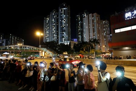Protesters light up their smartphones as they form a human chain during a rally to call for political reforms in Hong Kong