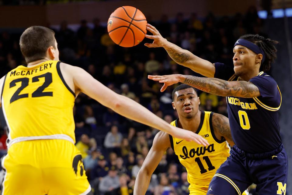 Michigan Wolverines guard Dug McDaniel (0) passes on Iowa Hawkeyes forward Patrick McCaffery (22) in the first half at Crisler Center in Ann Arbor on Saturday, Jan. 27, 2024.